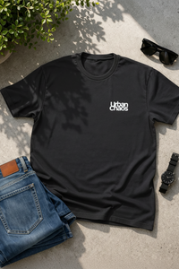 Navy blue t-shirt with 'Urban chaos' text on a concrete surface with jeans and sunglasses.
